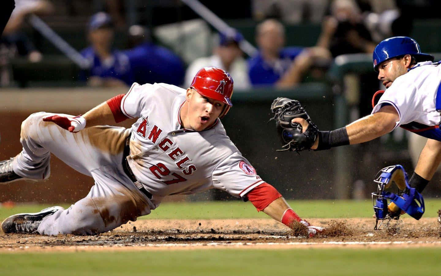 A Baseball Player Sliding Into Base Wallpaper