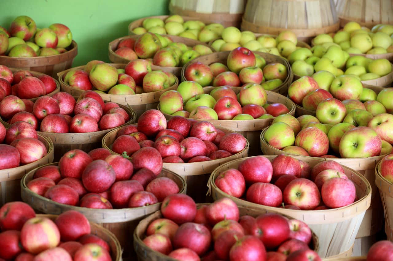 A Basket Of Freshly Picked Fall Apples Wallpaper