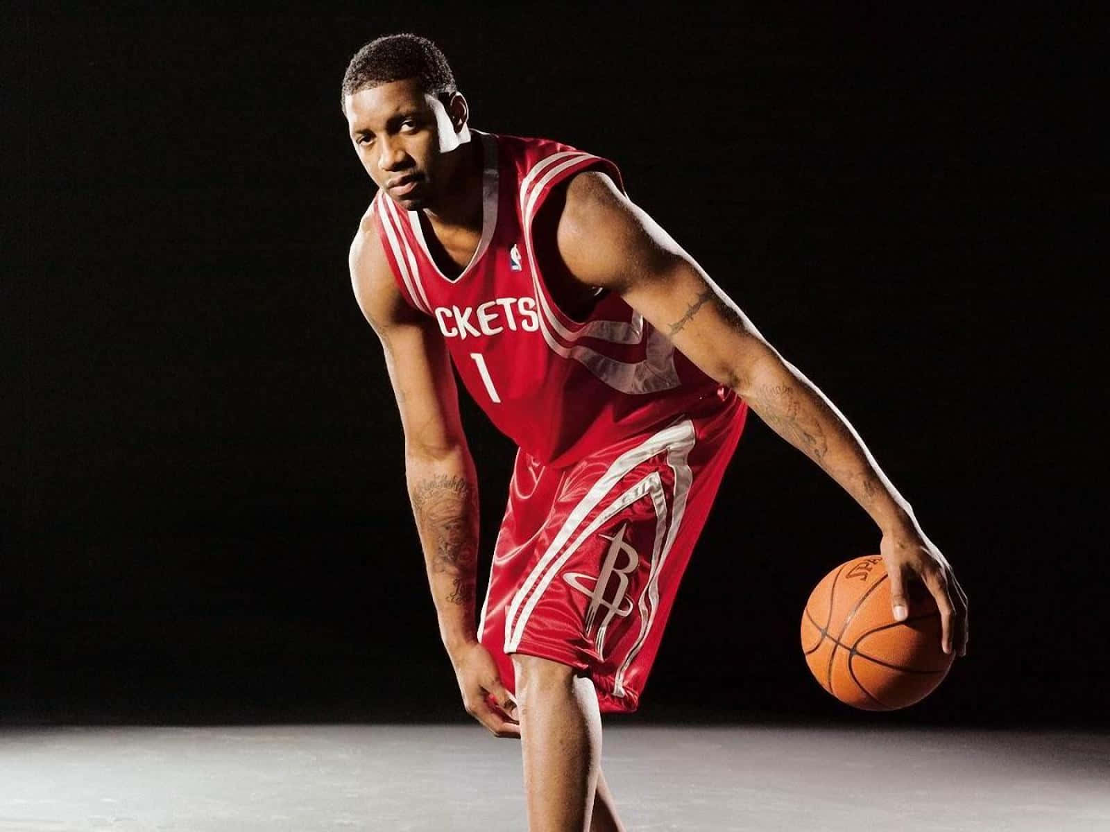 A Basketball Player In Red Uniform Posing For A Photo Wallpaper