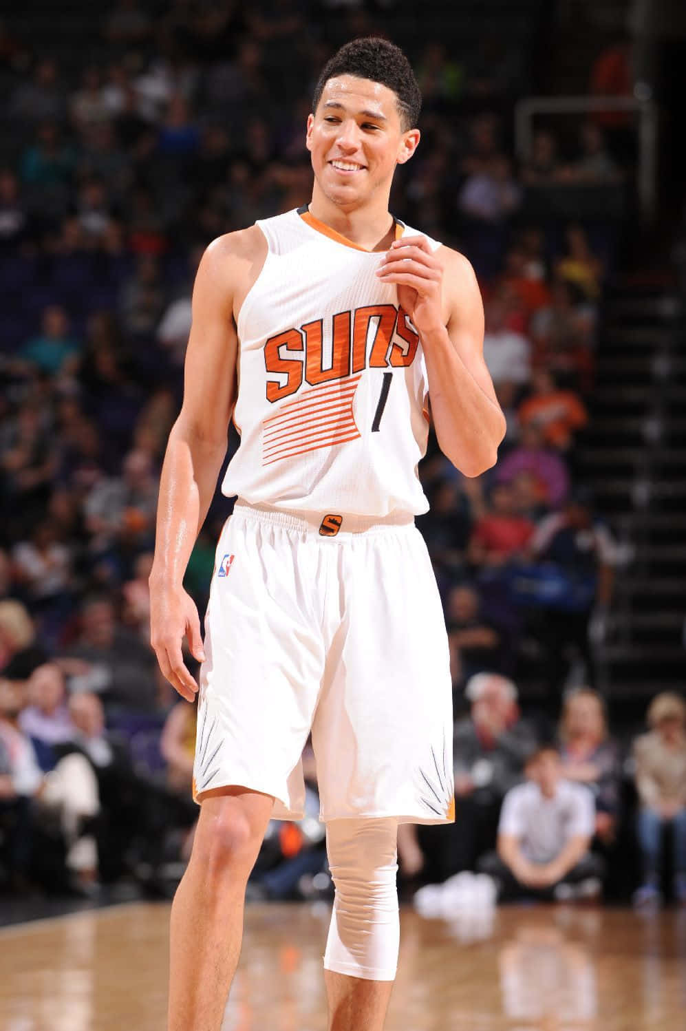 A Basketball Player Is Smiling On The Court Wallpaper