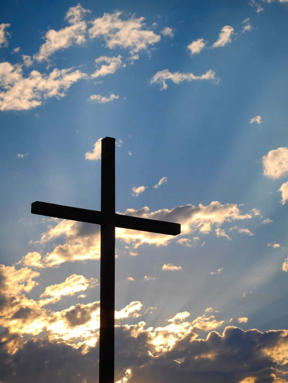 A Beautiful Cross On A Cloudy Sky Wallpaper