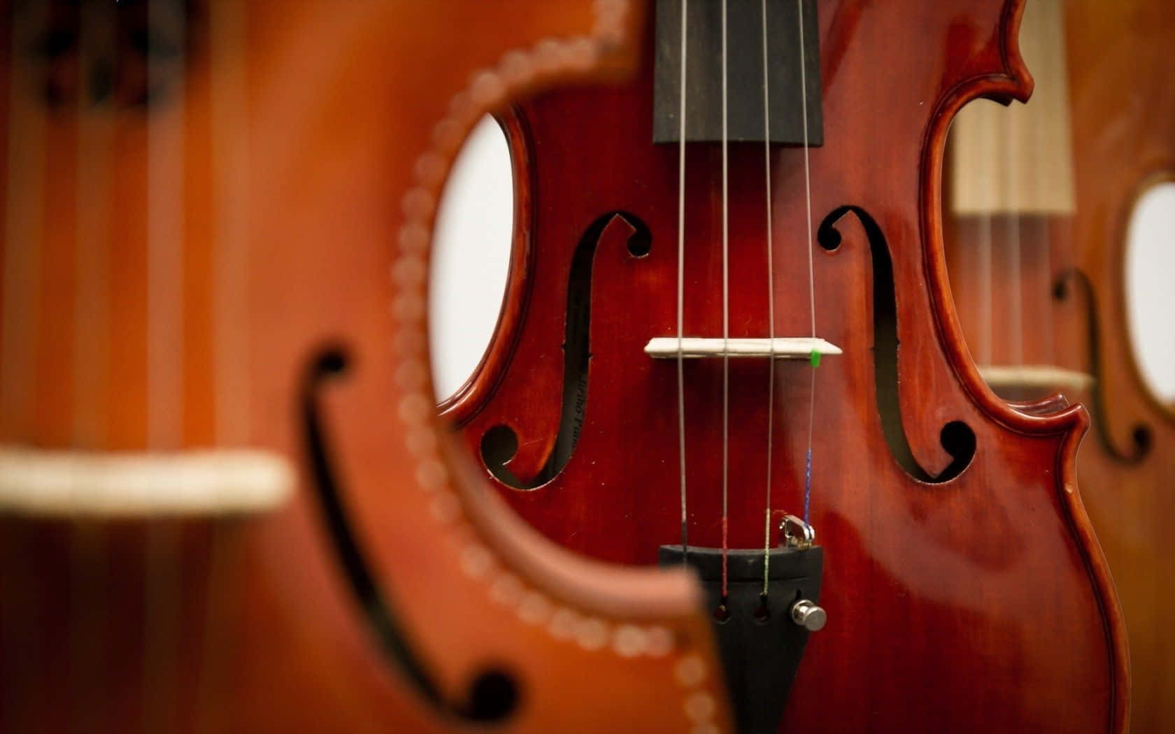 A Beautiful Four-string Violin Radiates A Soulful And Haunting Sound Wallpaper