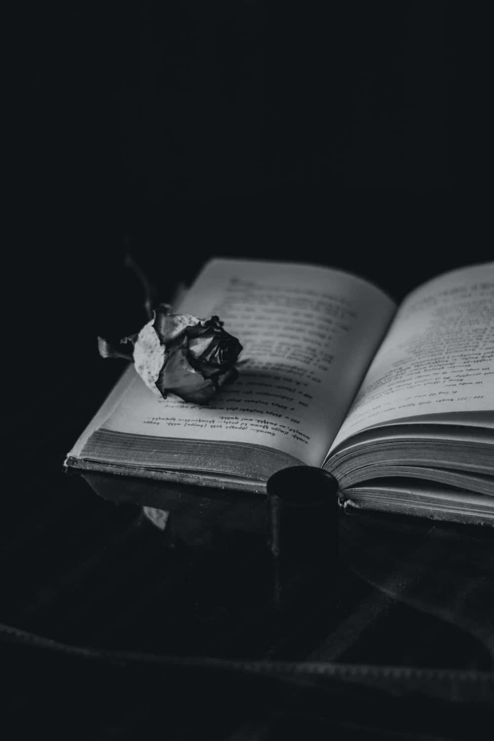 A Black And White Photo Of An Open Book Wallpaper