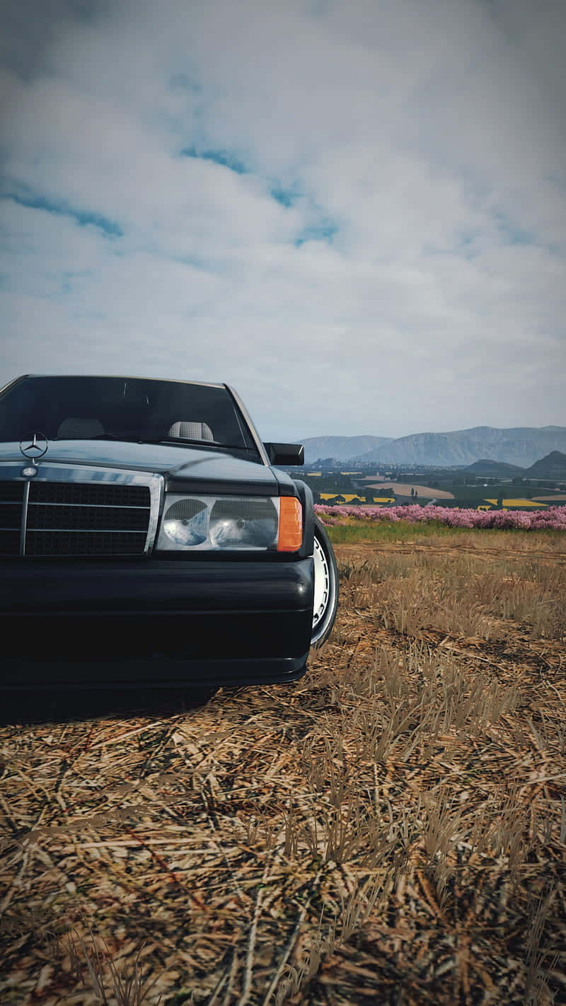 A Black Car In A Field Wallpaper