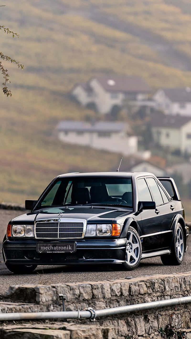 A Black Car Is Parked On A Hillside Wallpaper