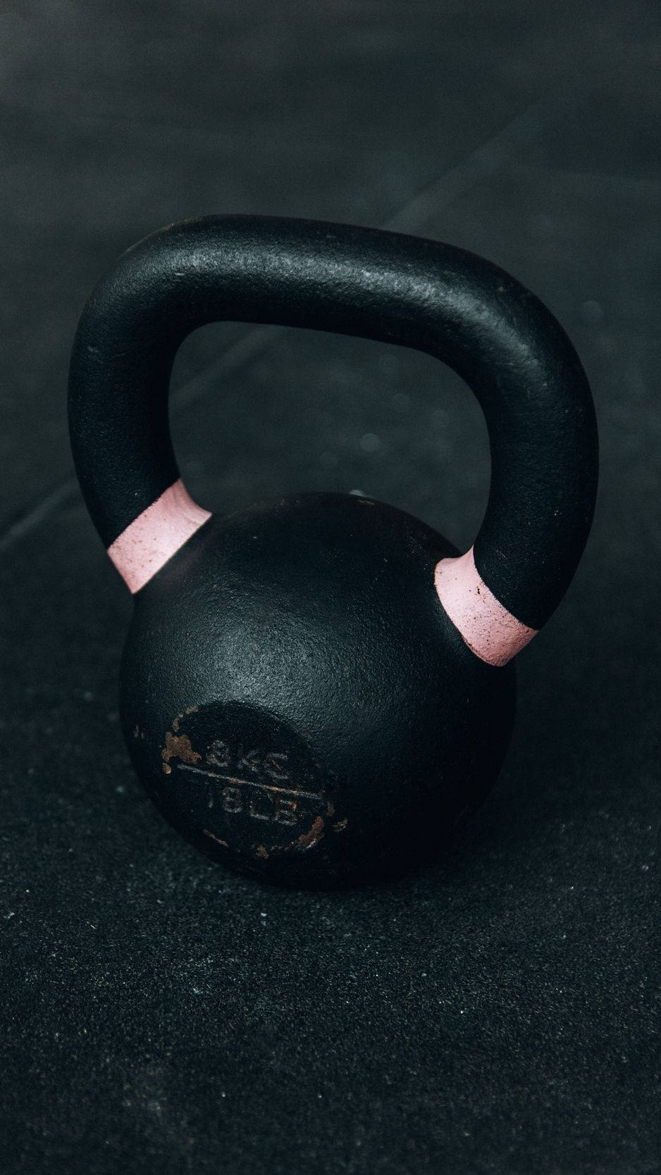 A Black Kettlebell On A Black Surface Wallpaper