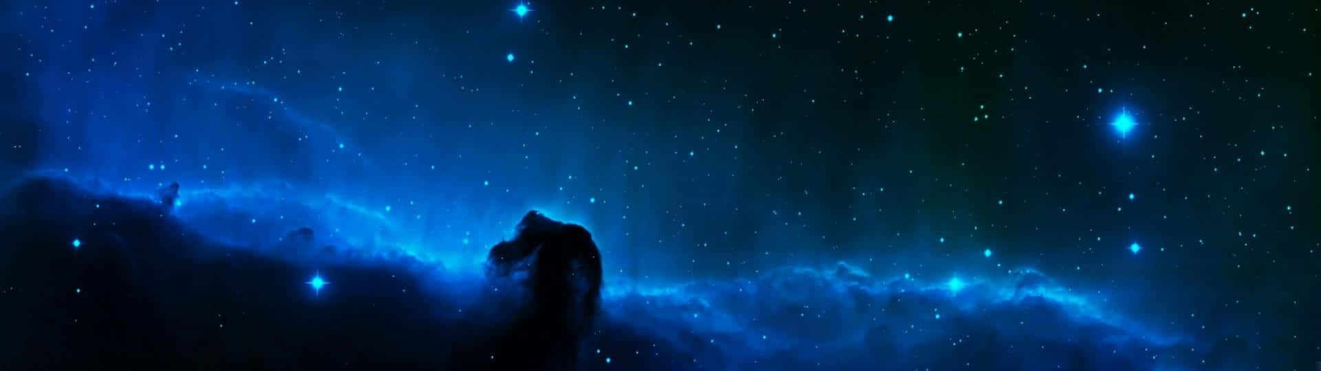 A Blue Space With Stars And Nebulas Wallpaper