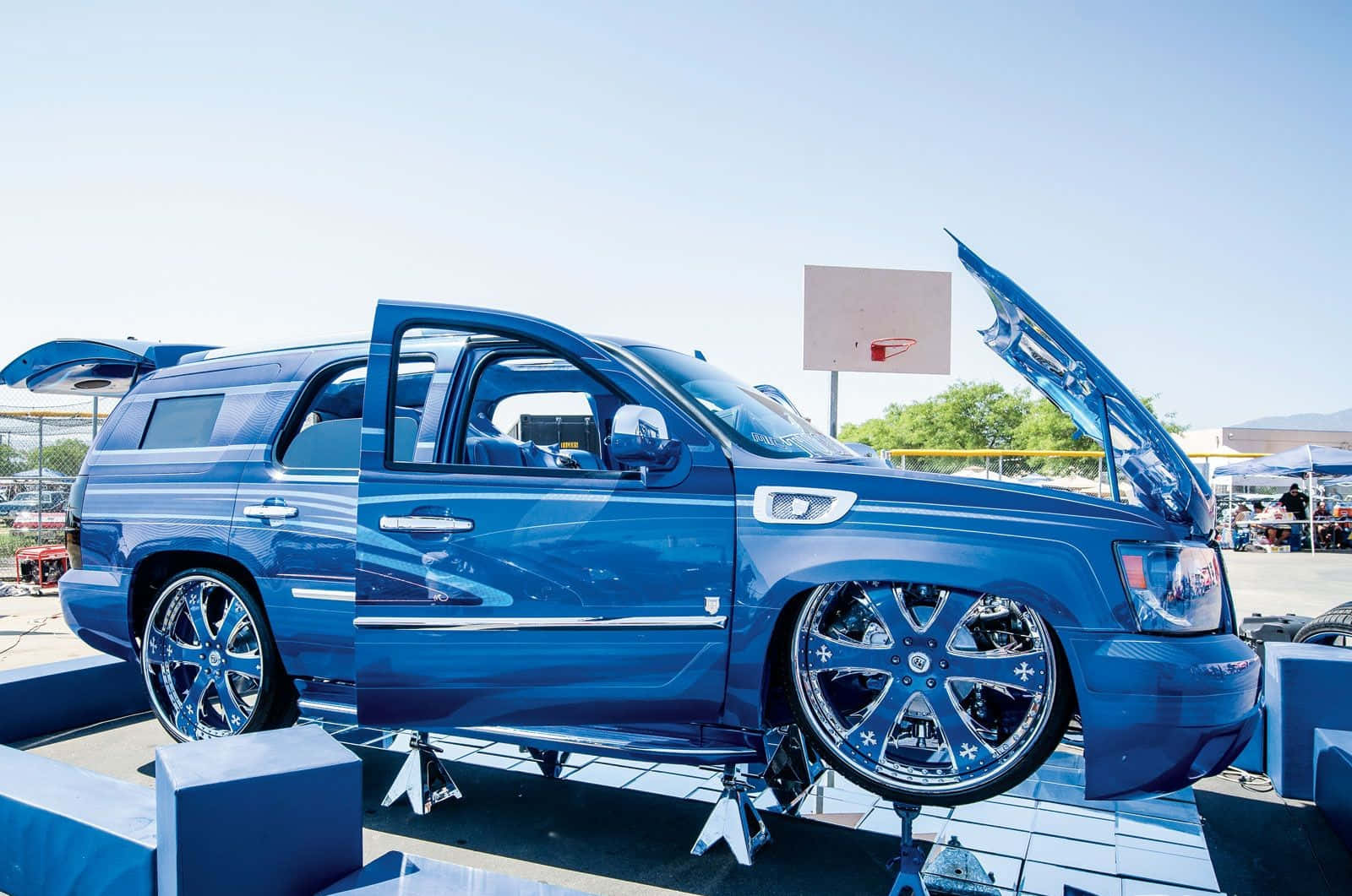 A Blue Suv With A Hood Open Wallpaper