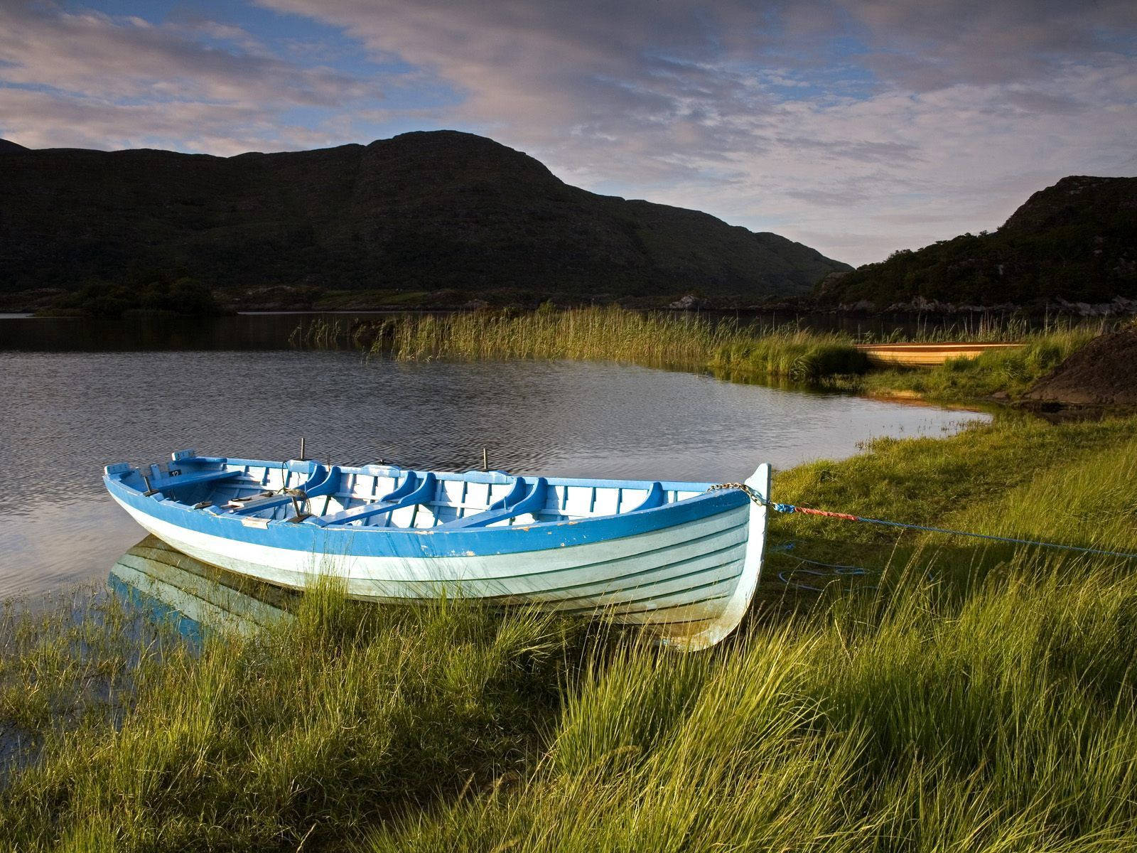 A Boat Gliding Peacefully Through The Calm River Shannon In Ireland Wallpaper