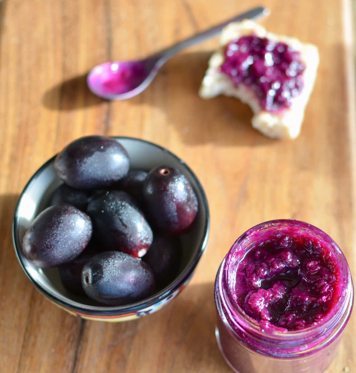 A Bowl Full Of Fresh Java Plums Beside A Jar Of Homemade Jam Wallpaper