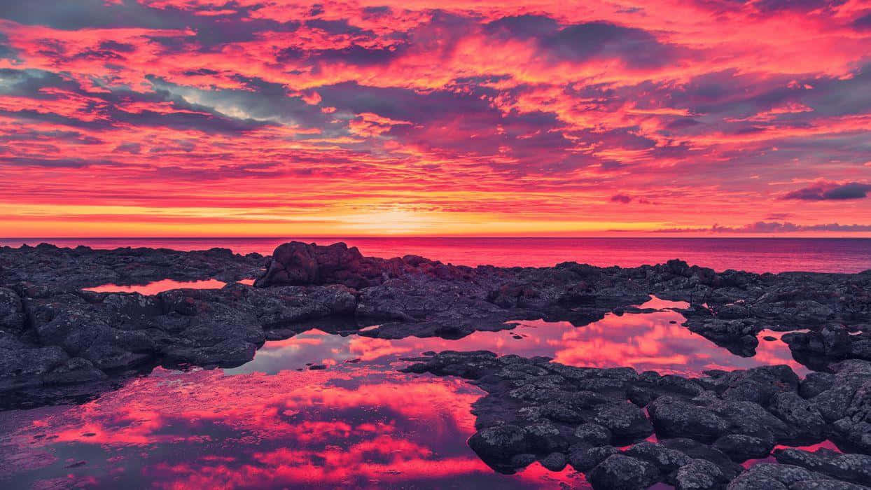 A Breathtaking Canvas Of Colors: Paint The Sky With The Hues Of A Vibrant Sunset Wallpaper