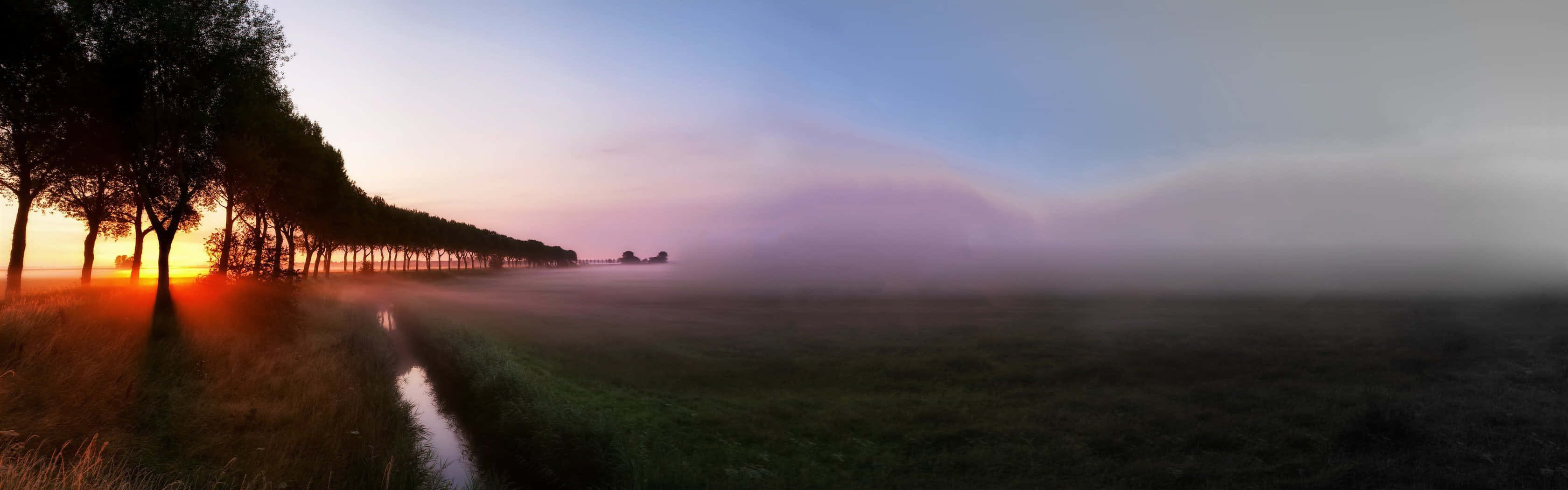 A Breathtaking View Of The Town On A Foggy Morning Wallpaper