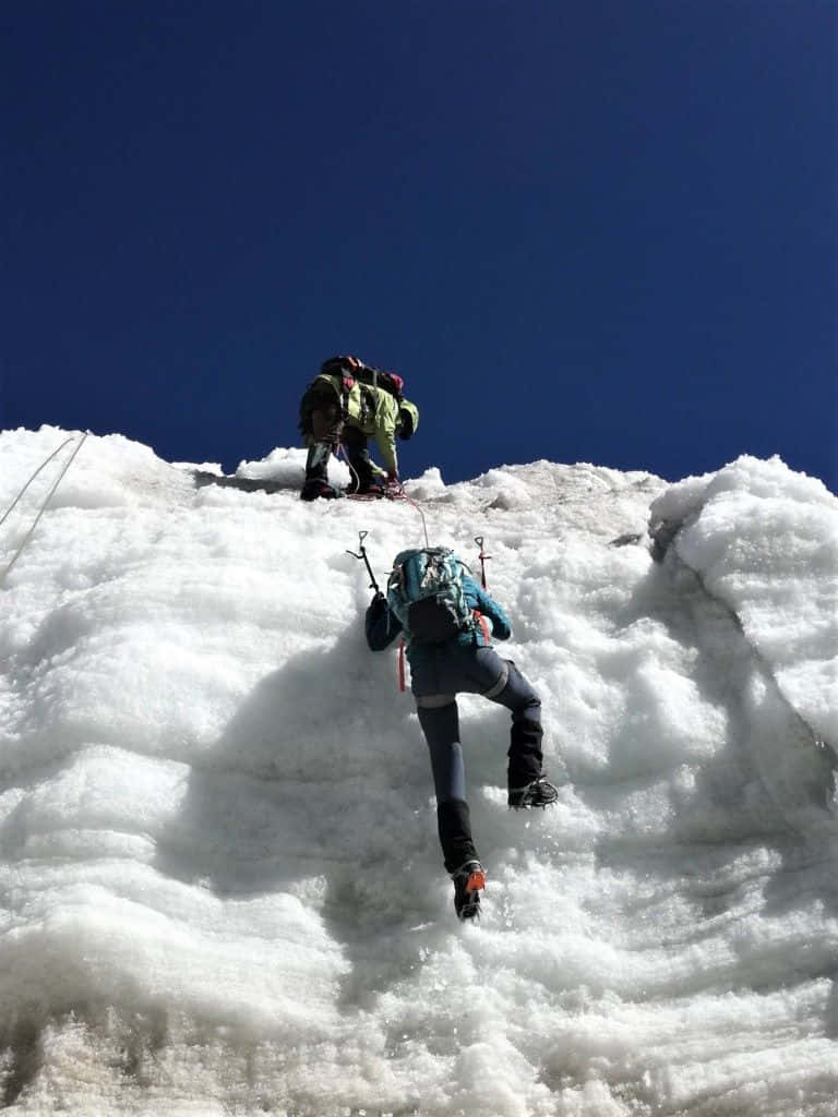 A Breathtaking Winter Hike Through A Snowy Landscape Wallpaper