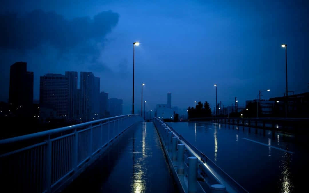 A Bridge With A City In The Background Wallpaper