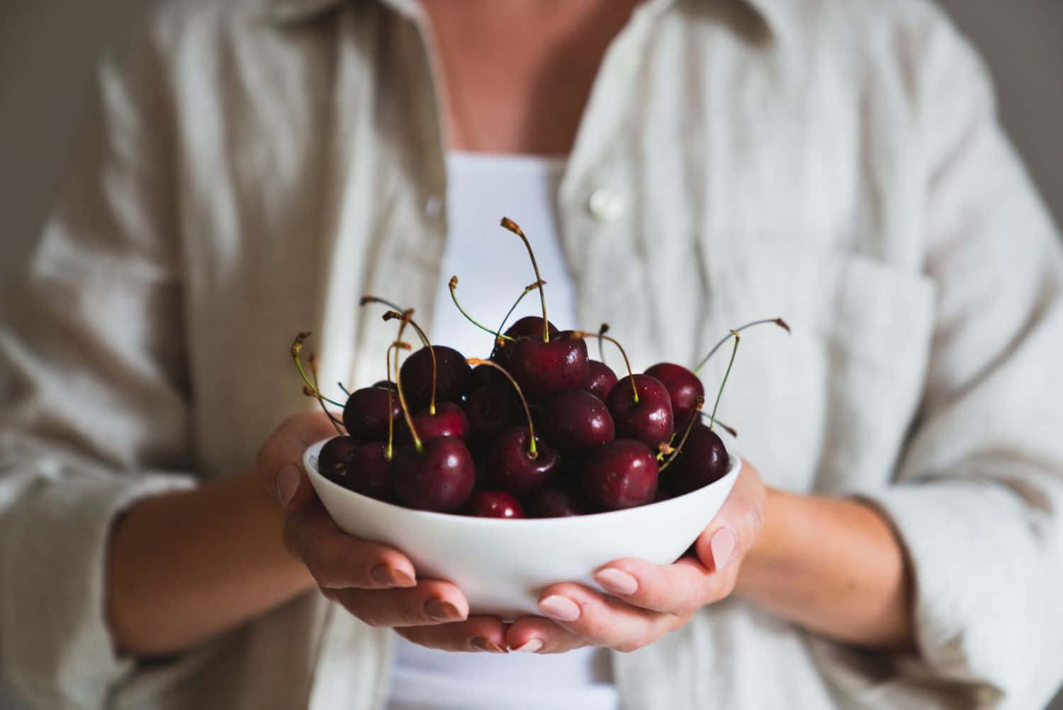 A Bunch Of Fresh Red Cherries On A Wooden Surface Wallpaper