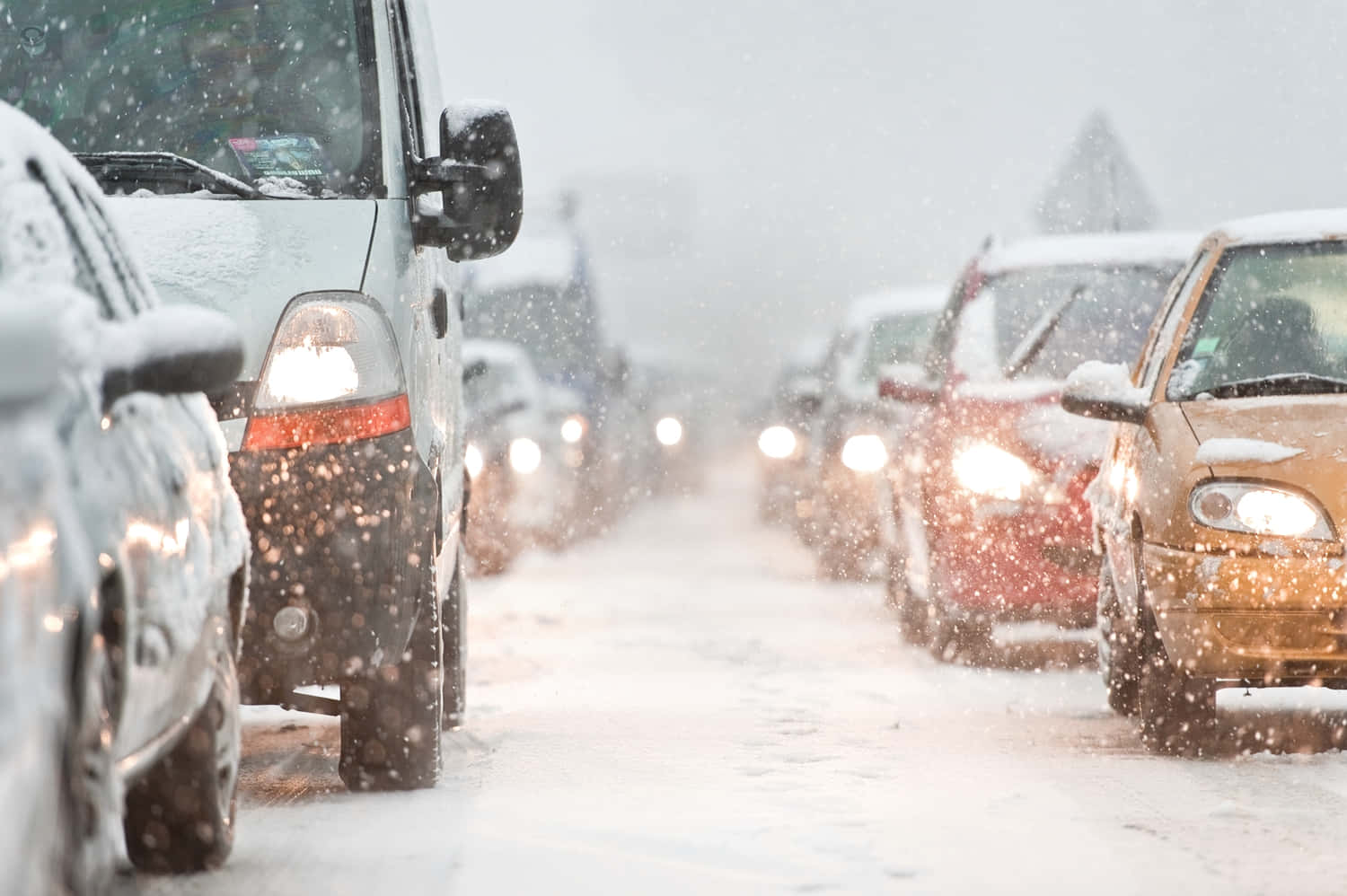 A Car Driving Through A Snowy Winter Landscape Wallpaper