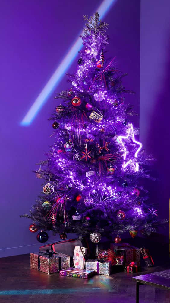 A Christmas Tree With Purple Lights In A Room Wallpaper