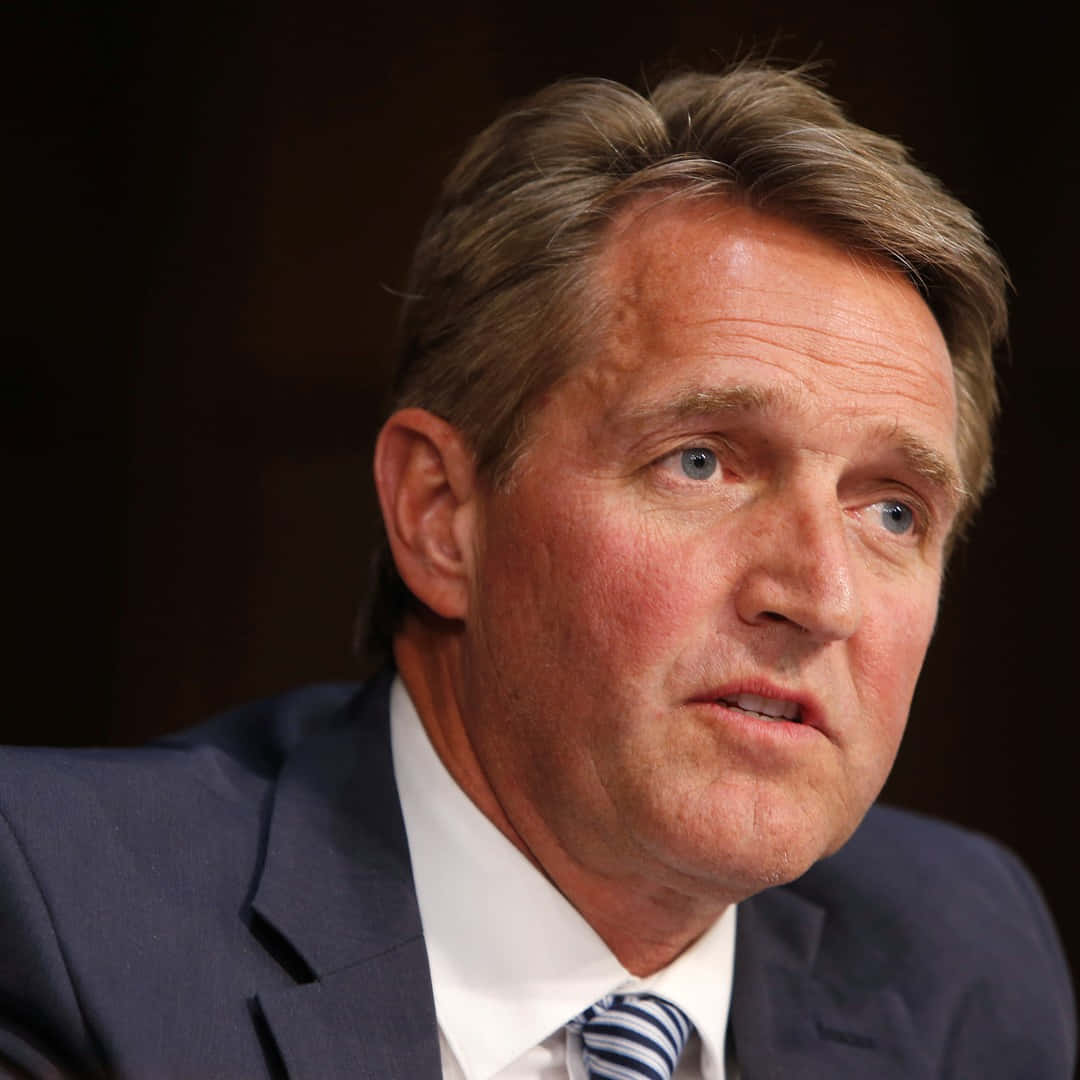 A Close-up Shot Of Jeff Flake Engaging In Conversation Wallpaper