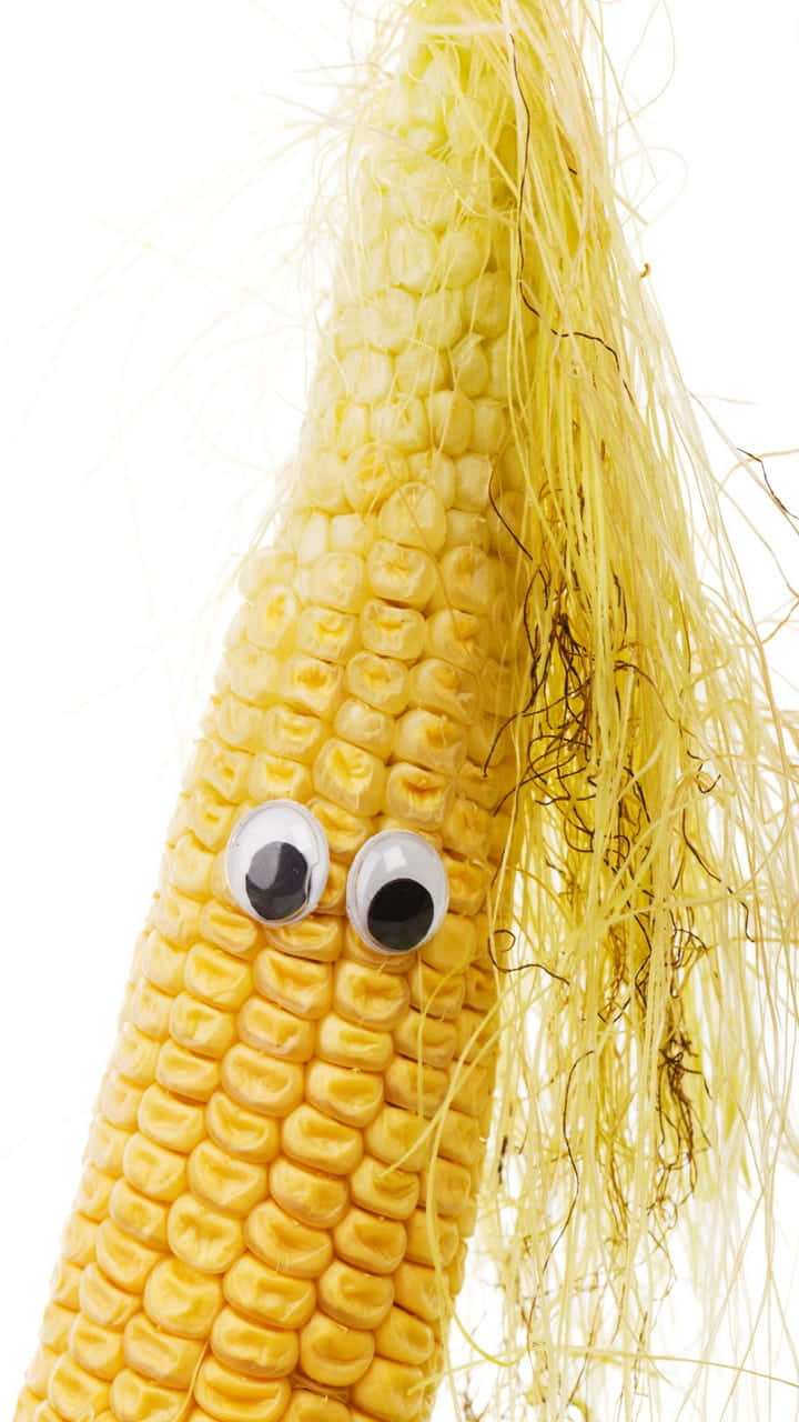 A Close-up View Of Fresh Yellow Corn Kernels On A Cob Wallpaper