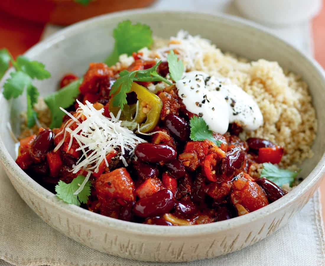 A Close-up View Of Vibrant Red Beans In A Ceramic Bowl Wallpaper