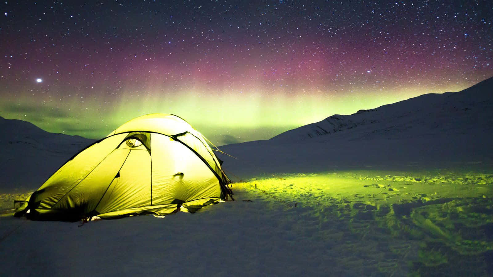 A Cozy Winter Camping Setup In A Snowy Forest Landscape Wallpaper