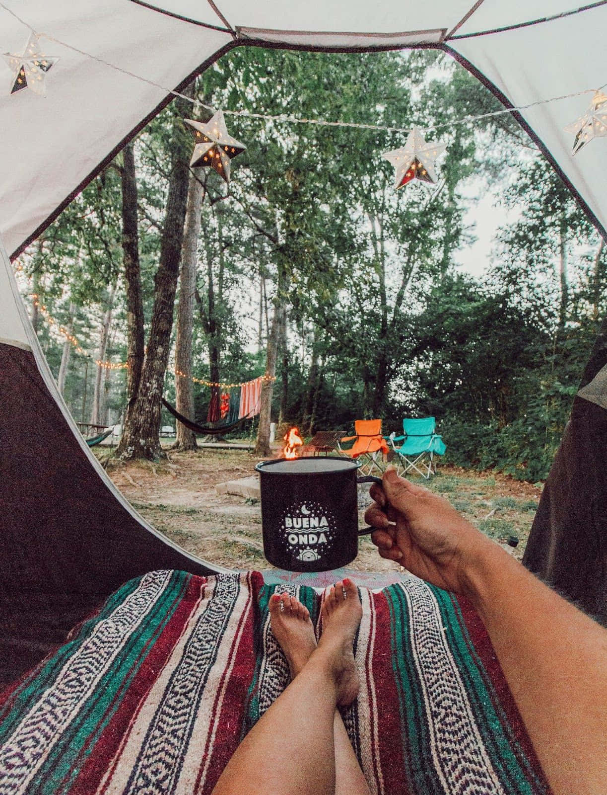 A Cozy Winter Campsite Amidst A Serene Snowy Landscape Wallpaper