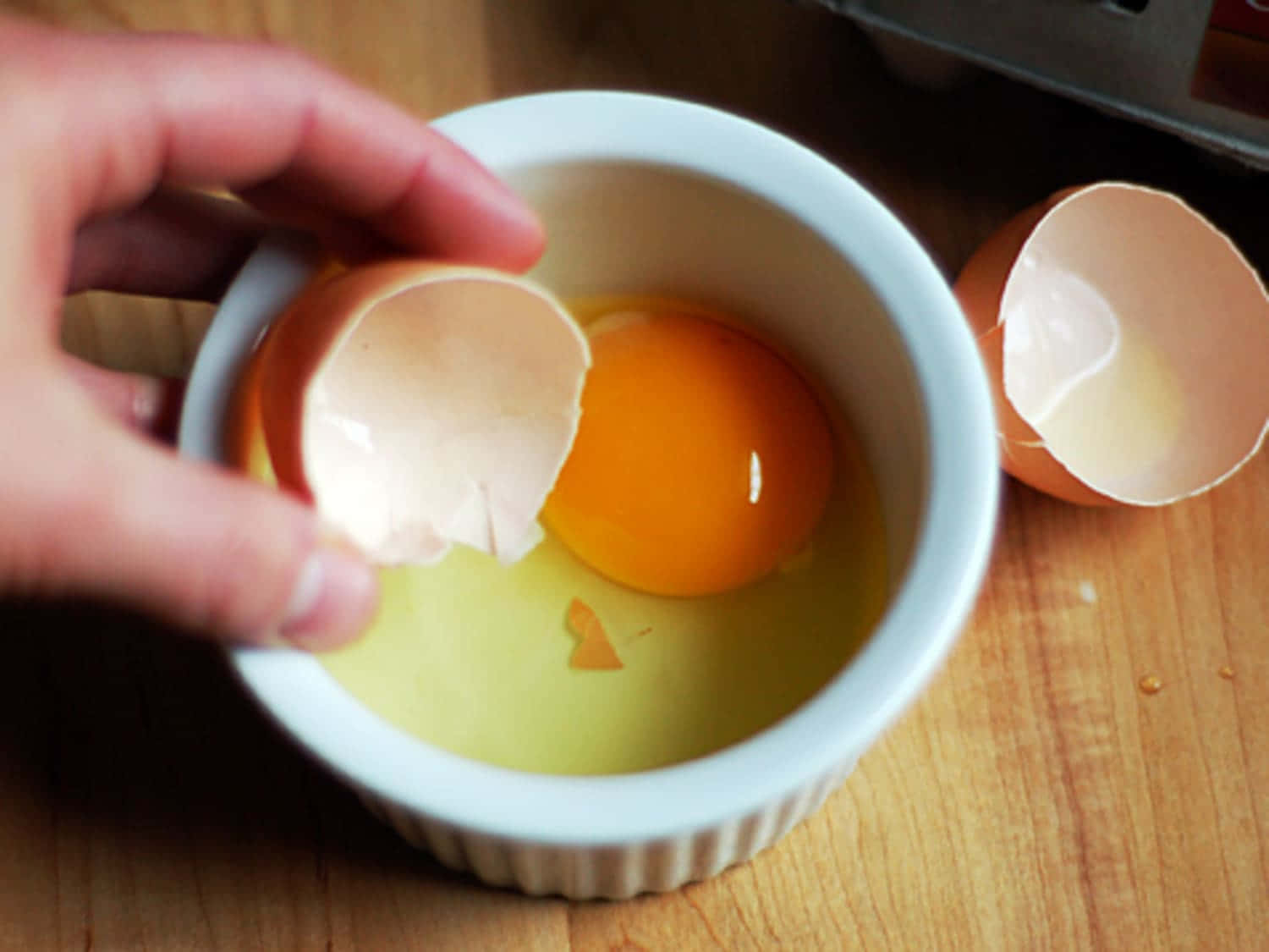 A Cracked Open Eggshell Showing A Half-peeled Yolk Wallpaper