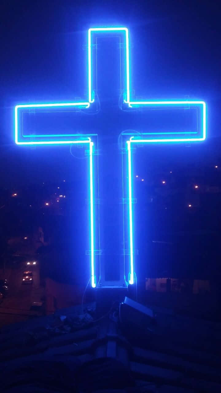 A Cross Shining With Blue Light Wallpaper