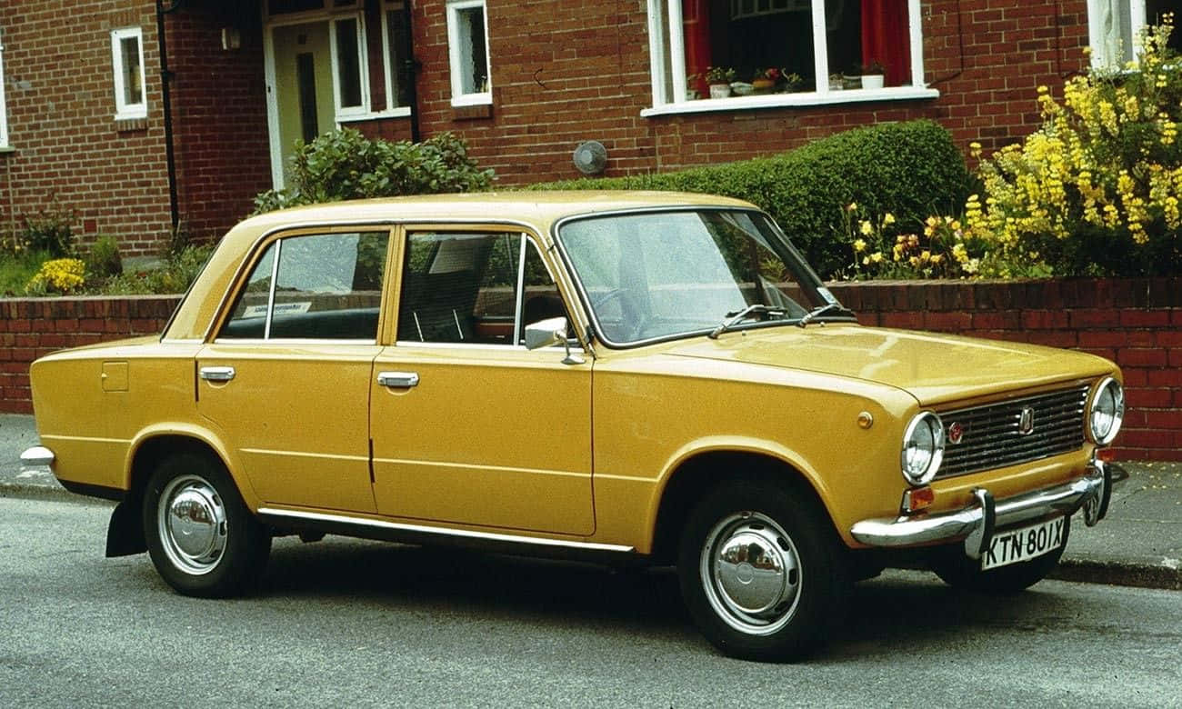 A Family Enjoying A Road Trip With Their Modern Family Car. Wallpaper