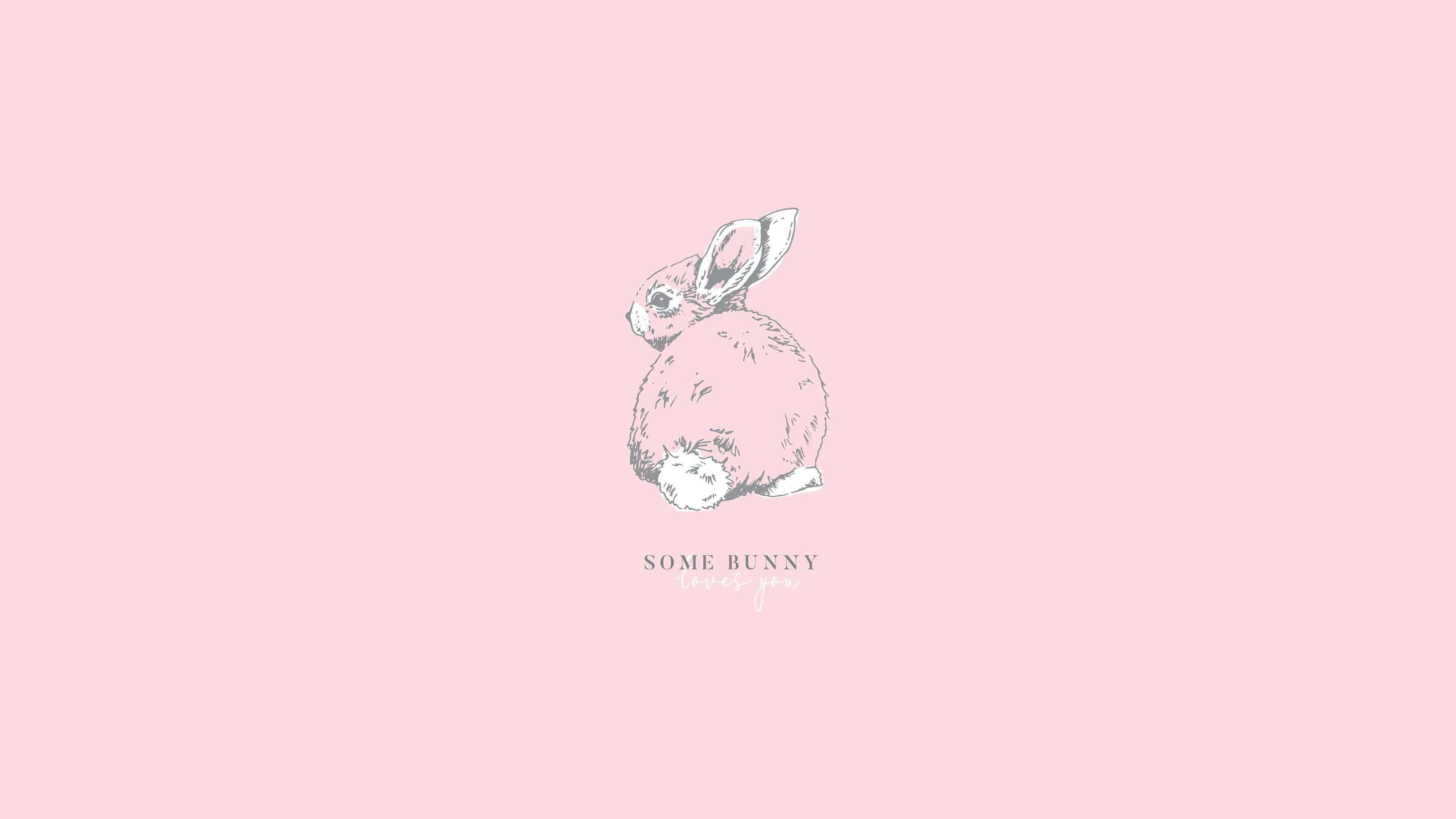 A Fluffy Pink Bunny Resting In A Patch Of Grass Wallpaper