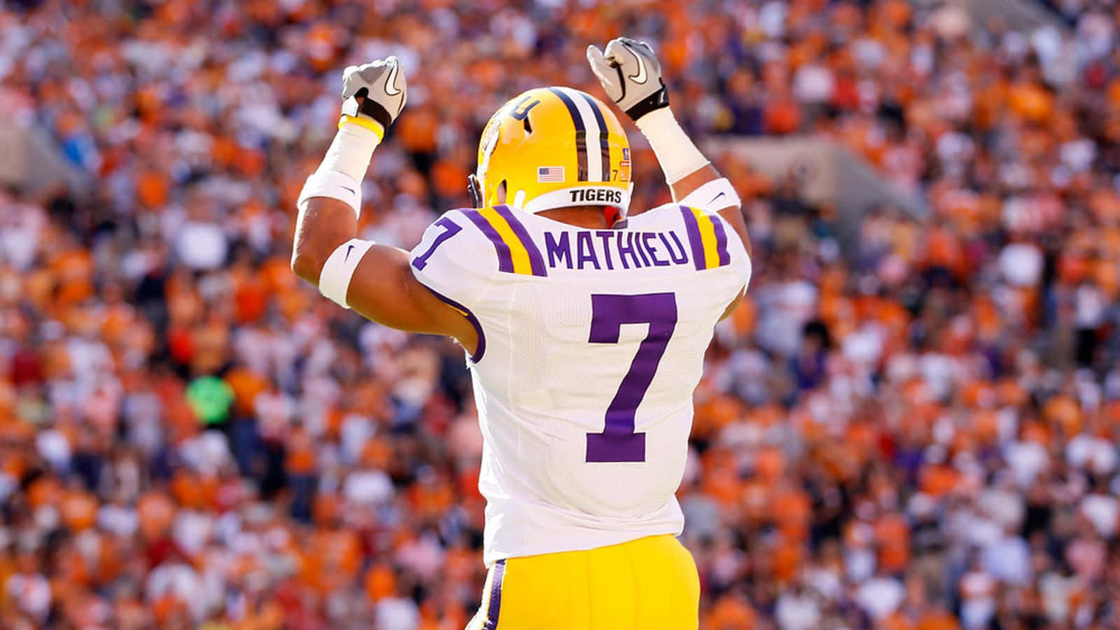 A Football Player Is Celebrating In Front Of An Audience Wallpaper