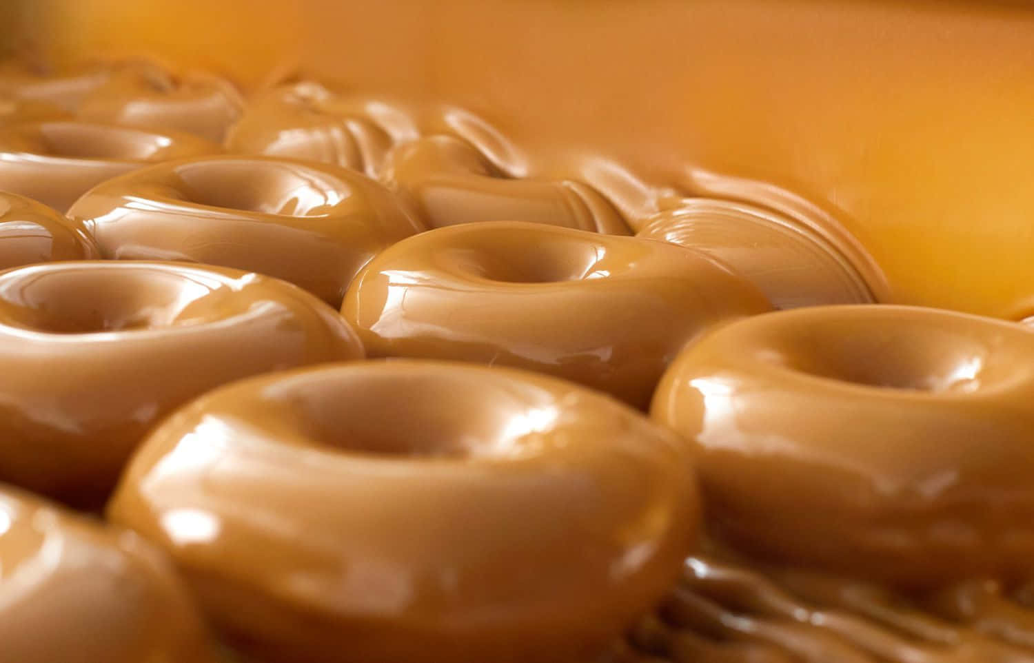 A Freshly Made Glazed Donut Ready For Your Breakfast Or Snack. Wallpaper