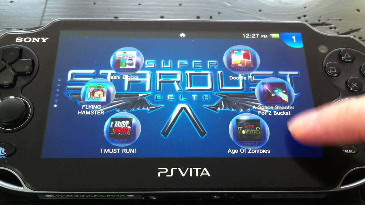 A Gamer Immersed In The World Of Ps Vita Wallpaper