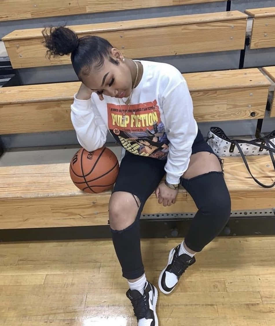 A Girl Sitting On A Bench With A Basketball Ball Wallpaper