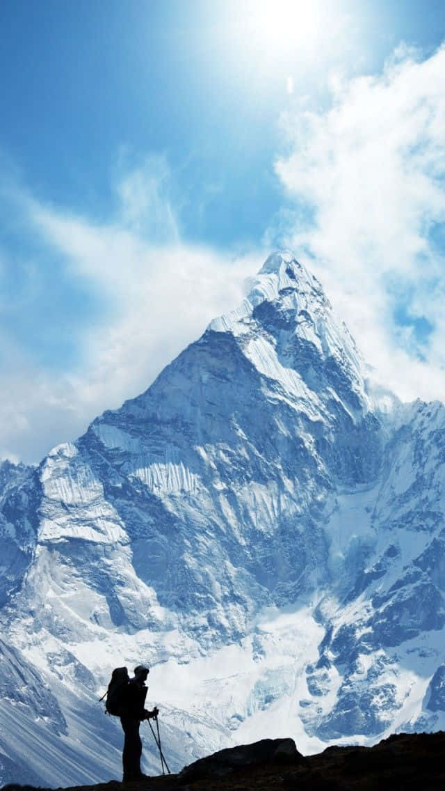 A Group Of Adventurous Hikers Trekking Through A Snowy Winter Landscape. Wallpaper