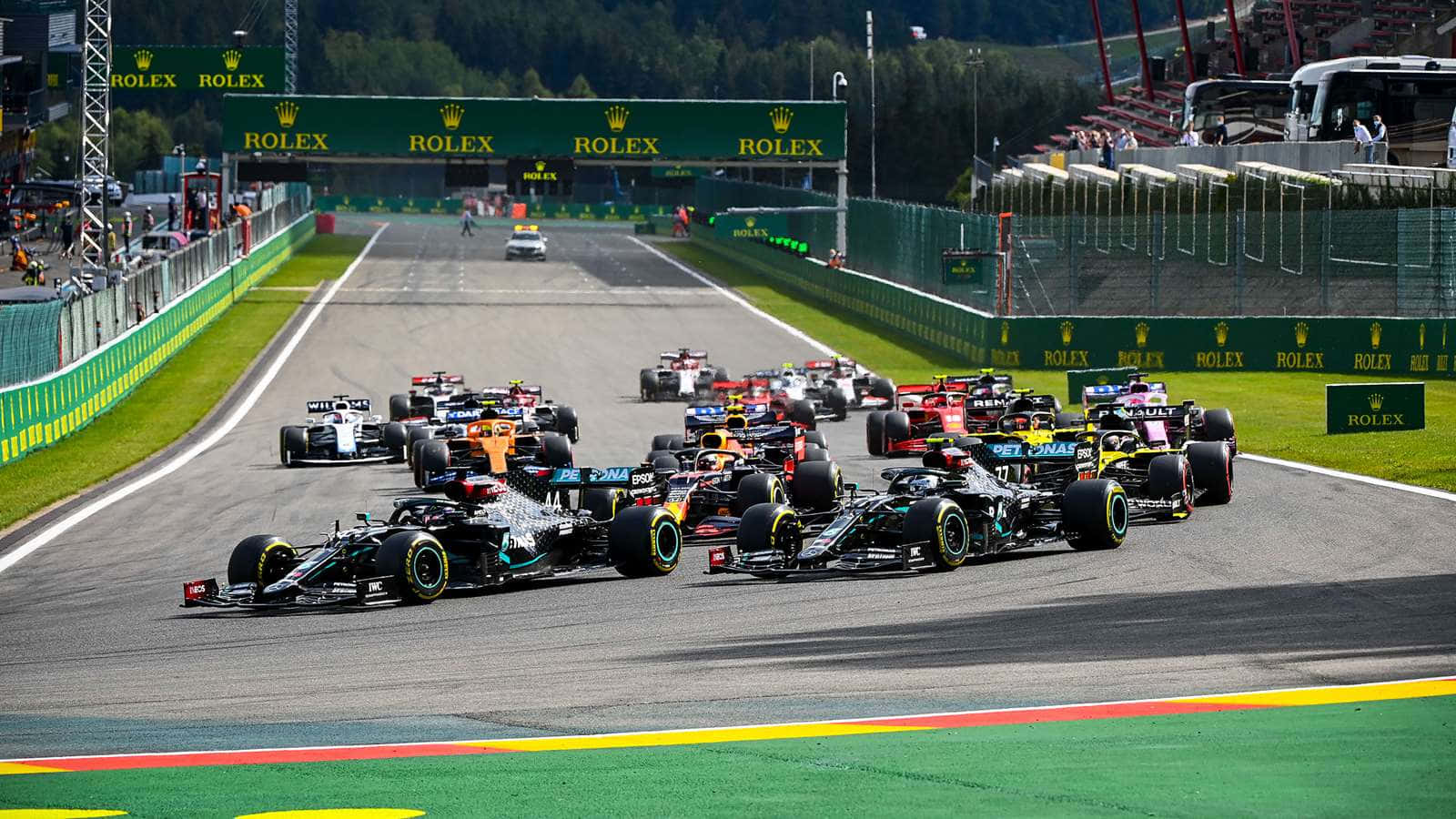 A Group Of Cars Driving Down A Race Track Wallpaper