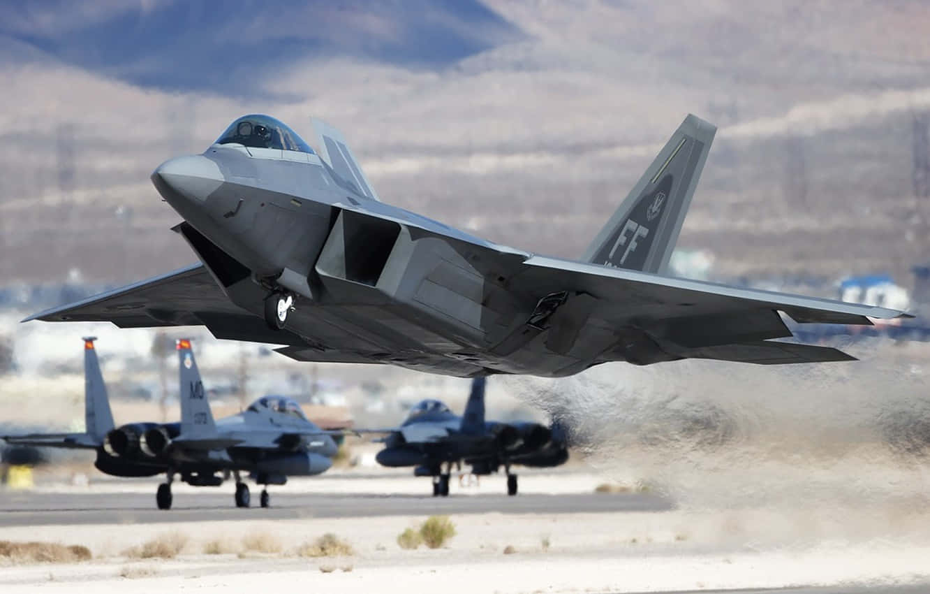 A Group Of Military Jets Are Taking Off From An Airport Wallpaper