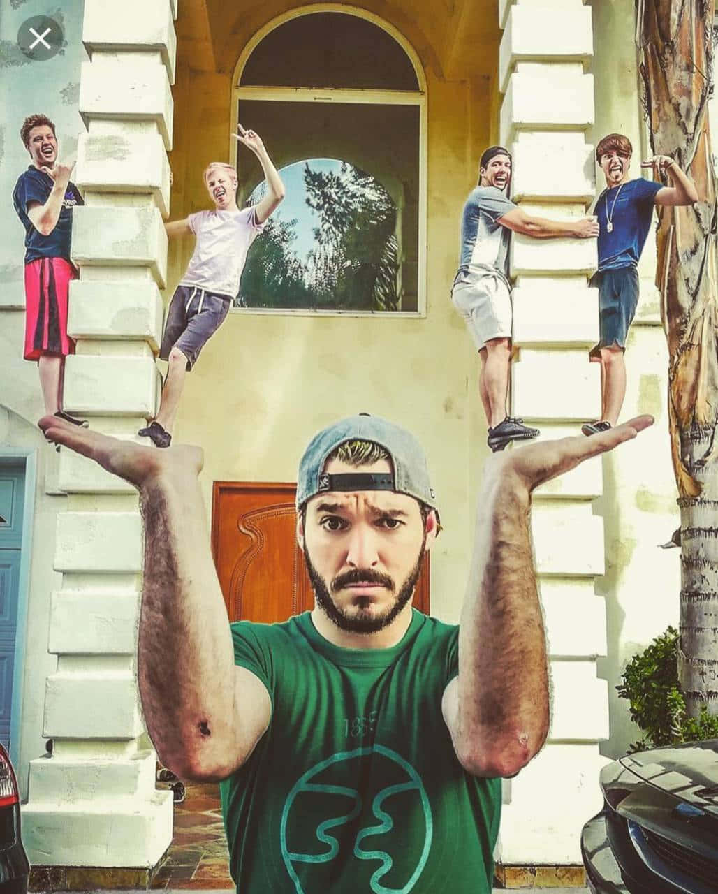 A Group Of People Posing In Front Of A House Wallpaper