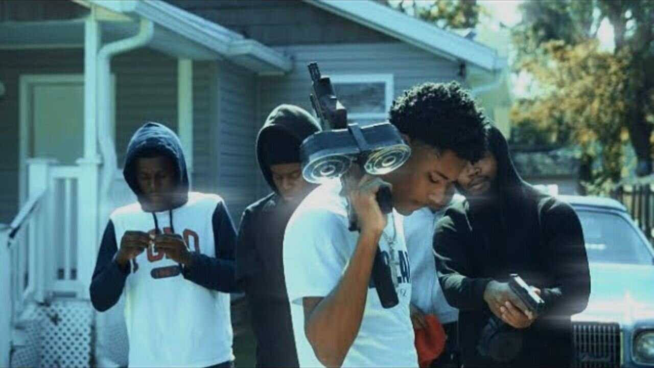 A Group Of People Standing In Front Of A House Wallpaper