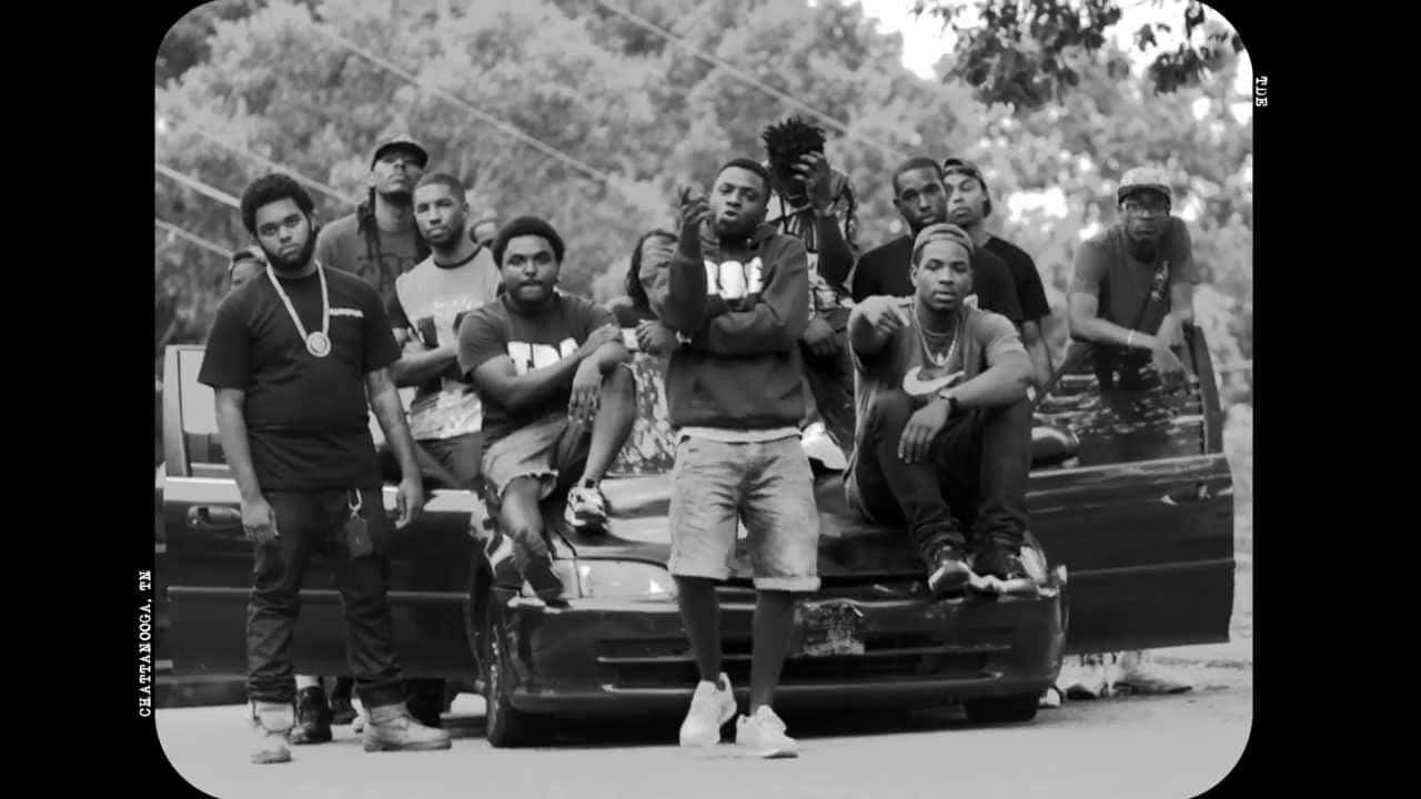 A Group Of People Standing Next To A Car Wallpaper