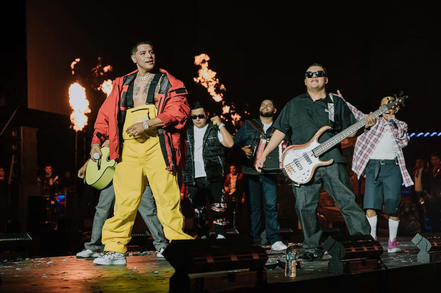 A Group Of People Standing On Stage With Guitars Wallpaper