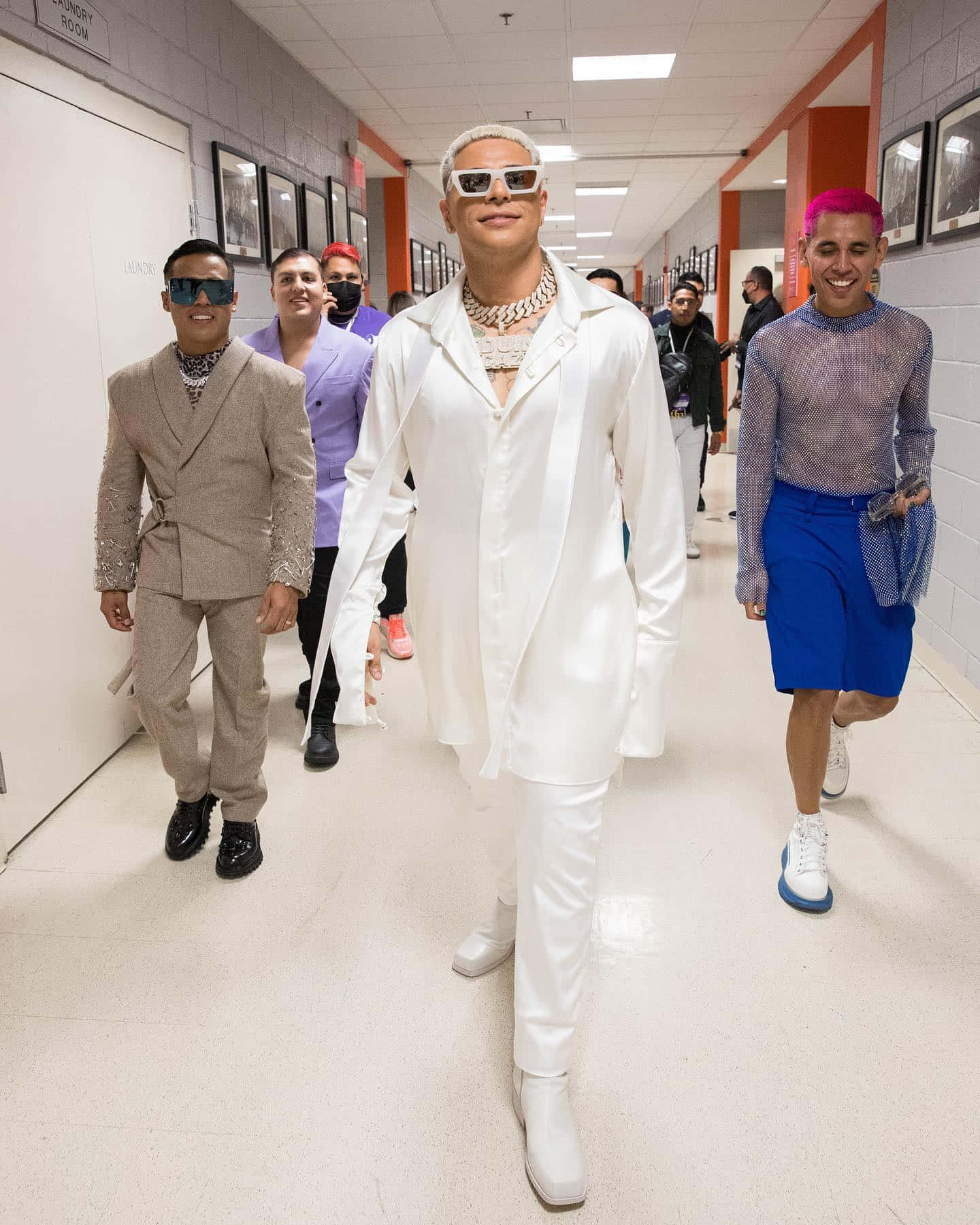 A Group Of People Walking Down A Hallway Wallpaper