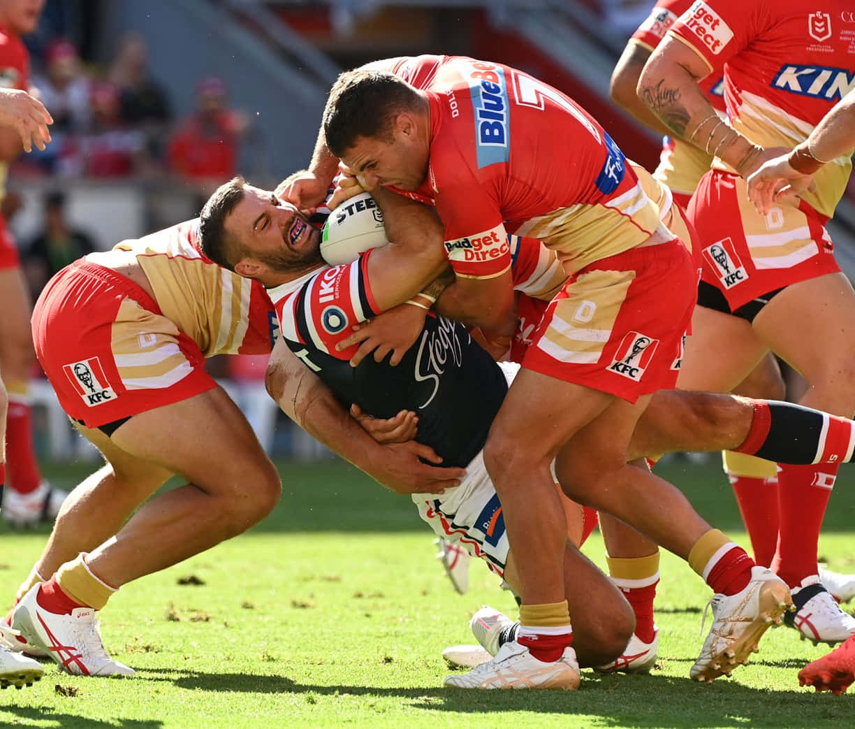 A Group Of Rugby Players Are Fighting For The Ball Wallpaper