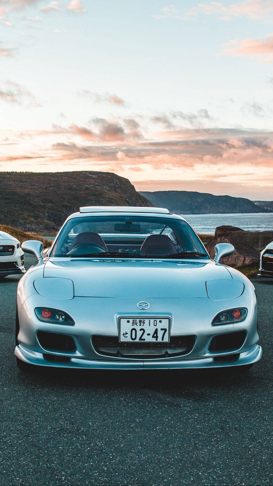 A Group Of Sports Cars Parked On A Road Wallpaper