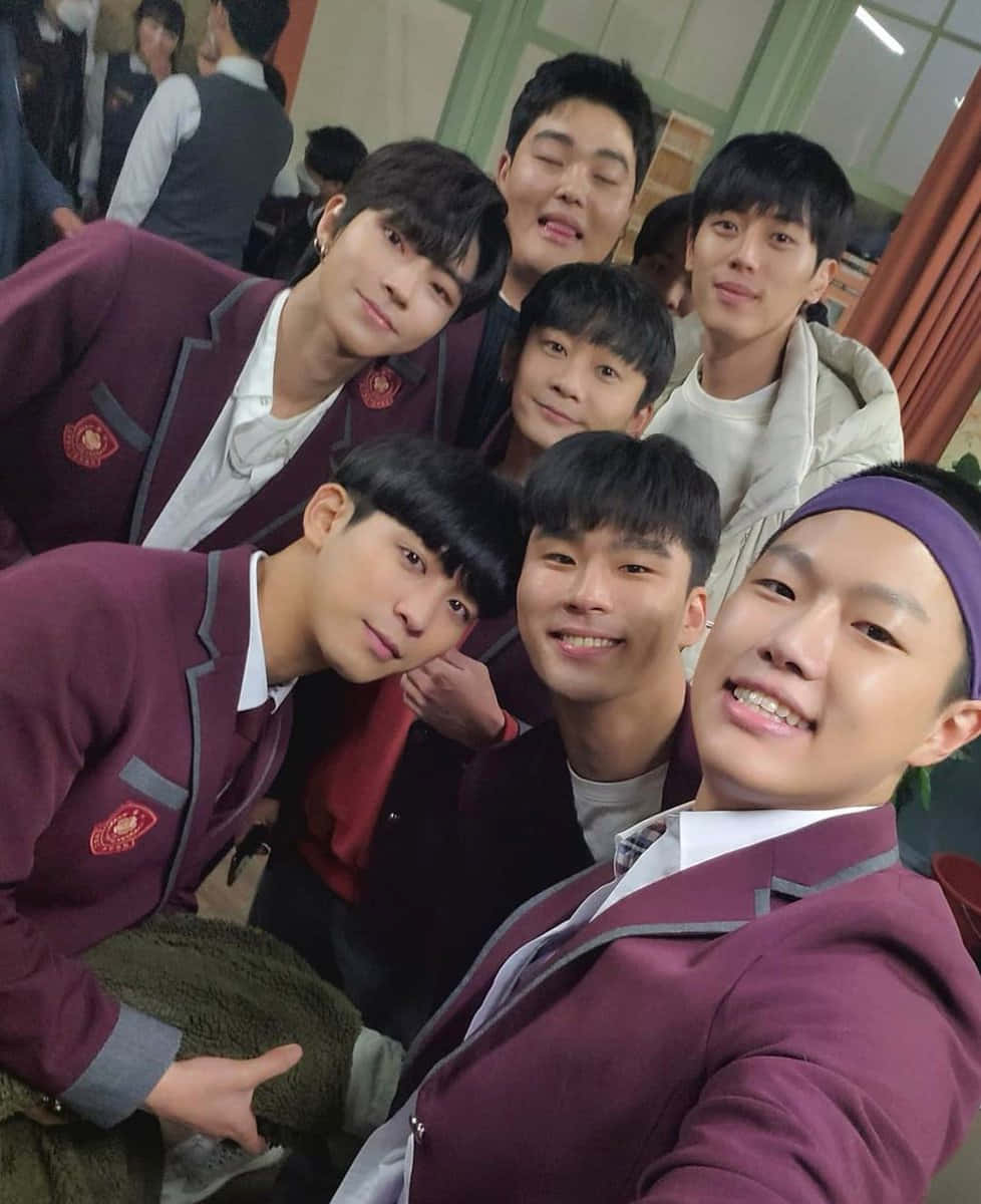 A Group Of Young Men In School Uniforms Posing For A Selfie Wallpaper