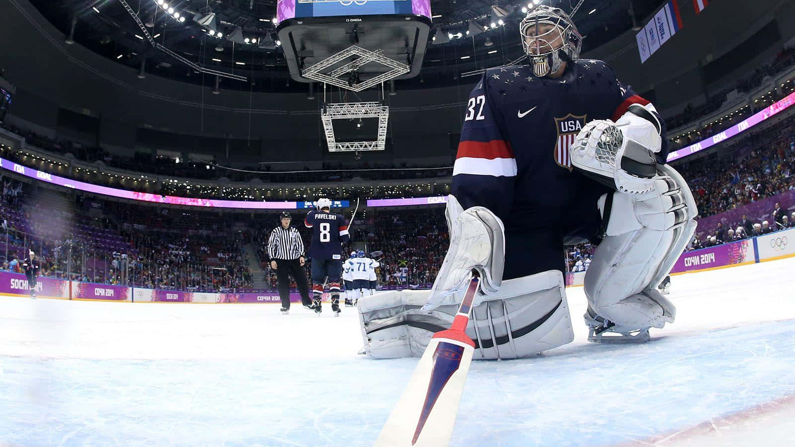 A Hockey Player Is Standing In Front Of A Goal Wallpaper