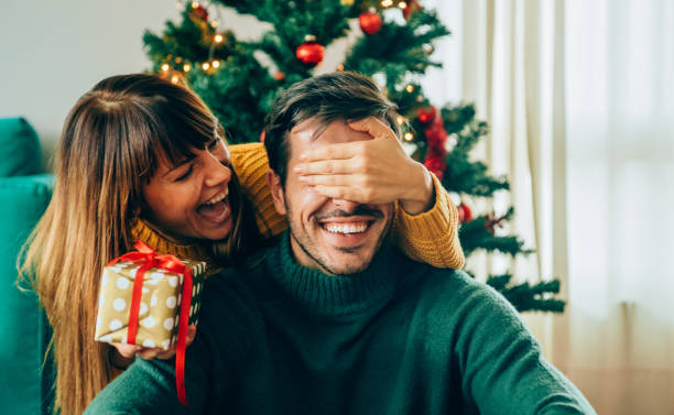 A Joyous Stack Of Christmas Presents Under The Sparkling Christmas Tree Wallpaper