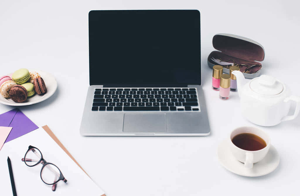 A Laptop, Coffee, And Other Items On A Table Wallpaper