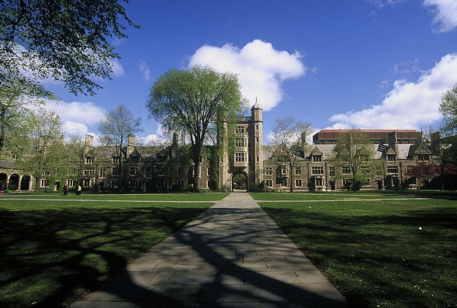 A Large Building With Trees And Grass In The Background Wallpaper