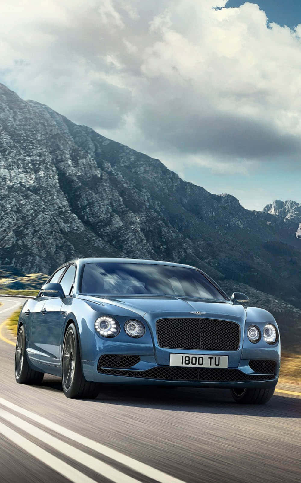 A Luxurious Bentley Flying Spur On An Open Road Wallpaper